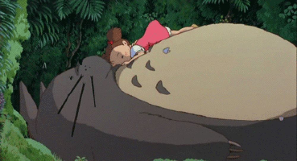 a girl in a pink dress is laying on a large animal