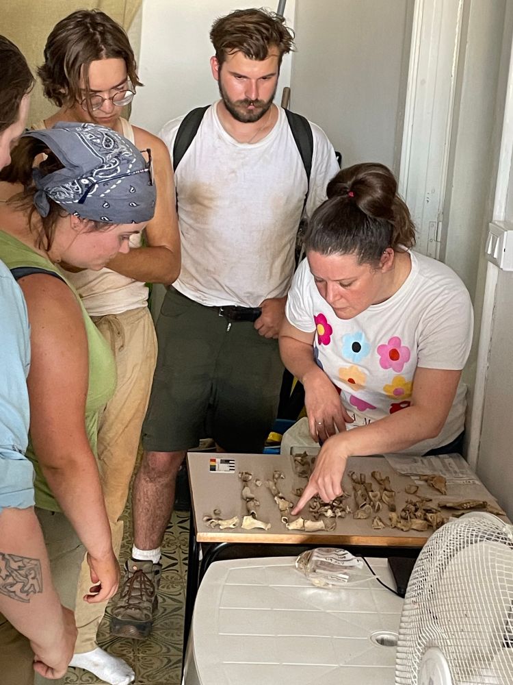 Hannah Russ points out some features on the bones while our students look on. 