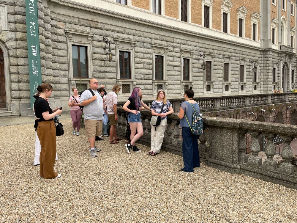 A group of students gather outside the museum to learn about the Roman theater