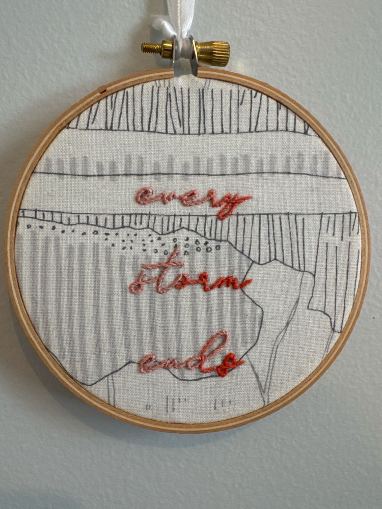 Embroidery hoop featuring the words “every storm ends”
