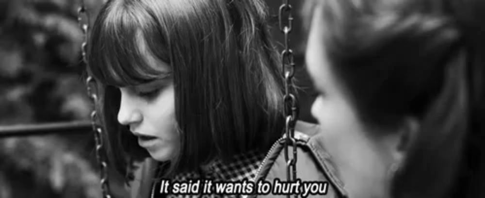 a black and white photo of two girls with the words it said it wants to hurt you