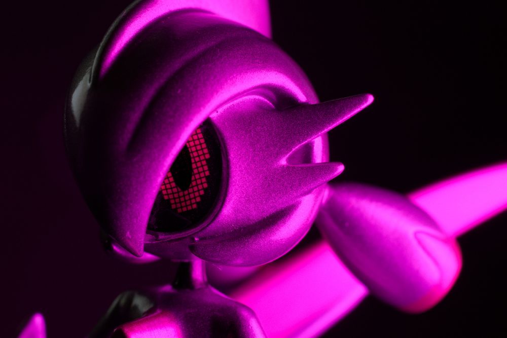 A close-up photo of a figure of a shiny Iron Valiant with a purple glow coming from the right side.