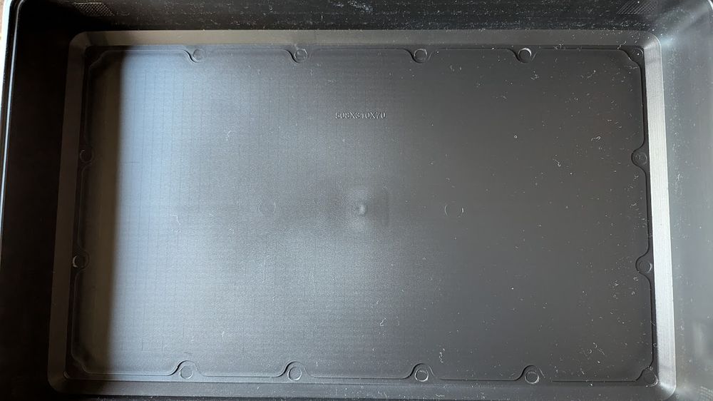 Inside the bottom of the AliExpress case, some round indents are spread around the edges