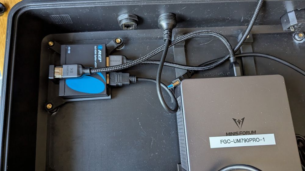 HDMI cables hooked up to the splitter. The input is connect via a 180 degree adapter so the all cables are facing the same direction.