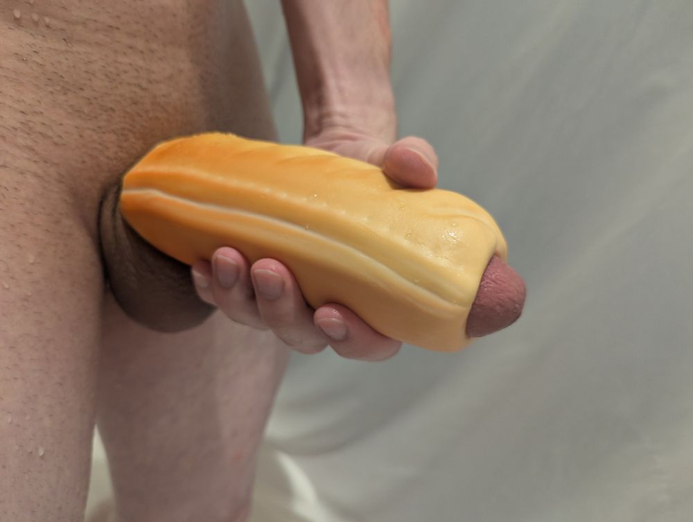 My dick in a toy shaped like a sausage roll. The tip is poking out and looks like sausage