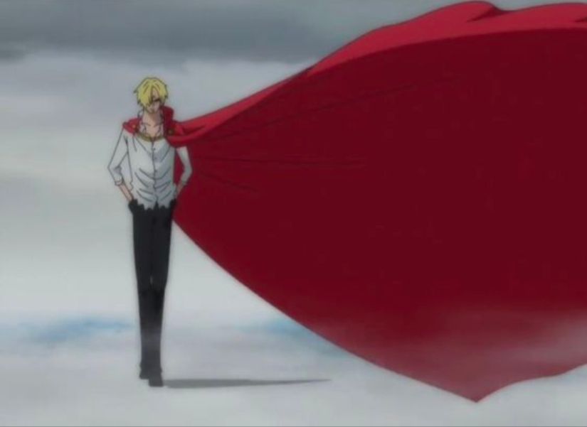 Sanji in his whole cake island look: black pants, rippled blouse, and long, red cape clasped with a gold chain. He has his hands in his pockets.