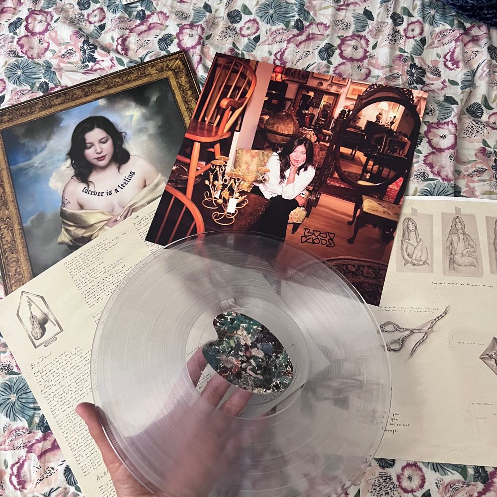 Clear vinyl of Forever is a Feeling by Lucy Dacus with lyric pages and a signed image of Lucy