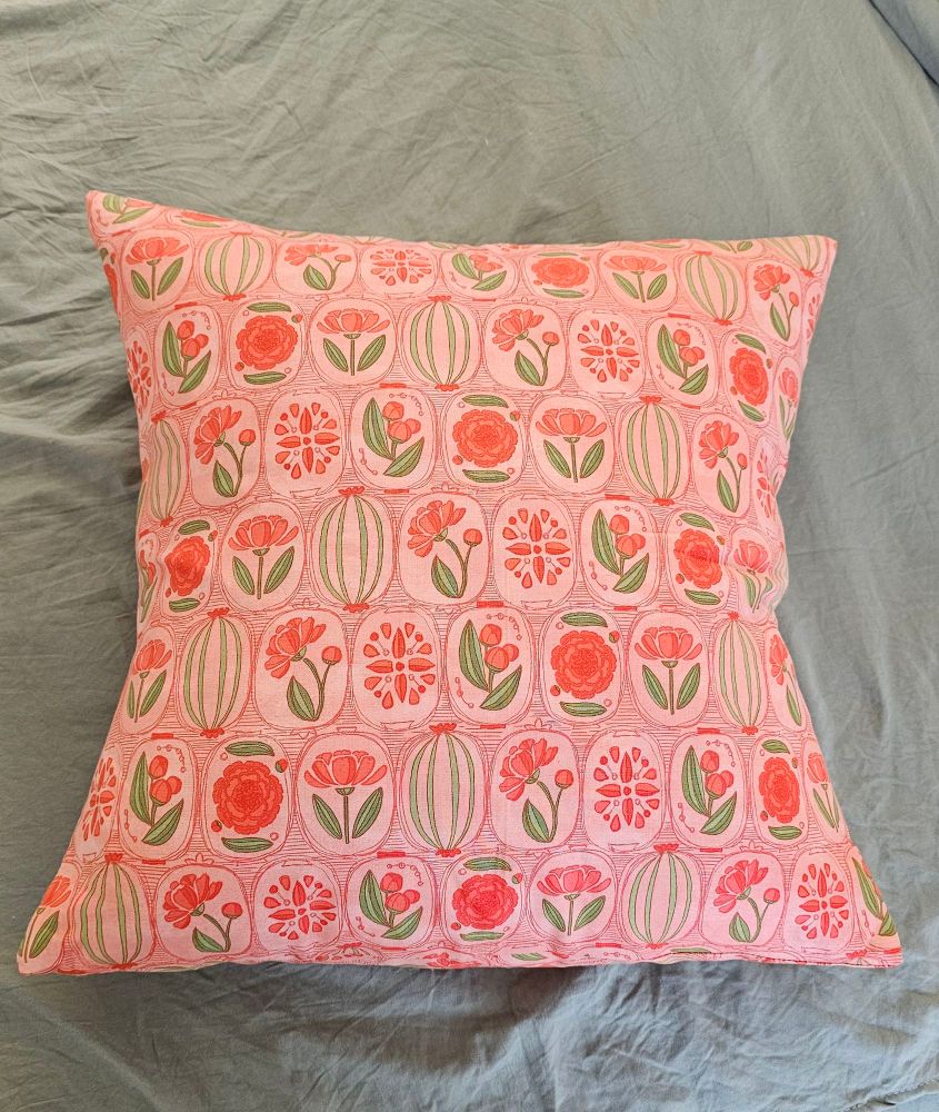 Image of a 16x16 pillow inside a blush pink fabric with peonies and greenery framed in ovals.