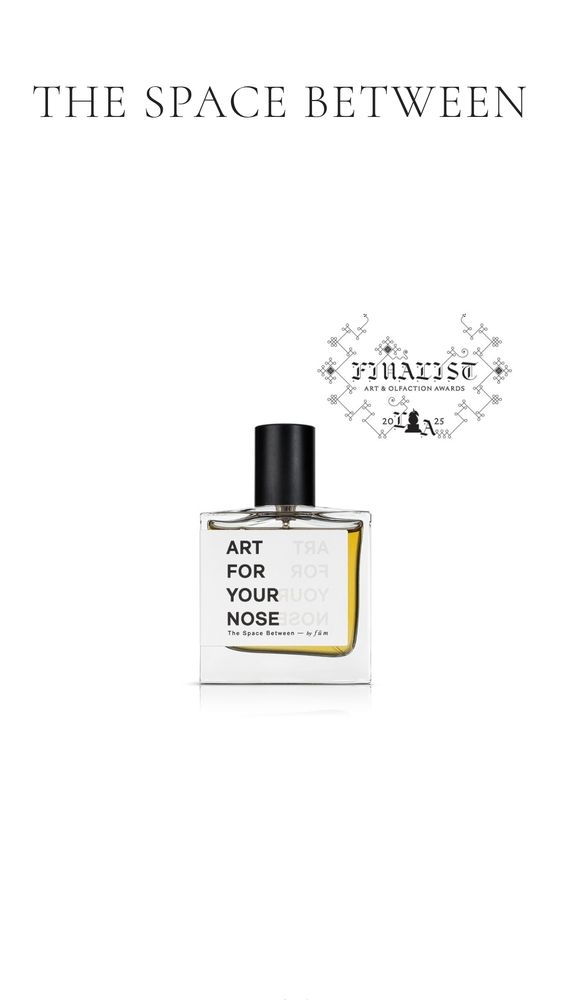 A square perfume bottle, black top, with bold text that says Art For Your Nose. In the upper right corner is an elaborate seal that reads FINALIST, Art and Olfaction Awards.