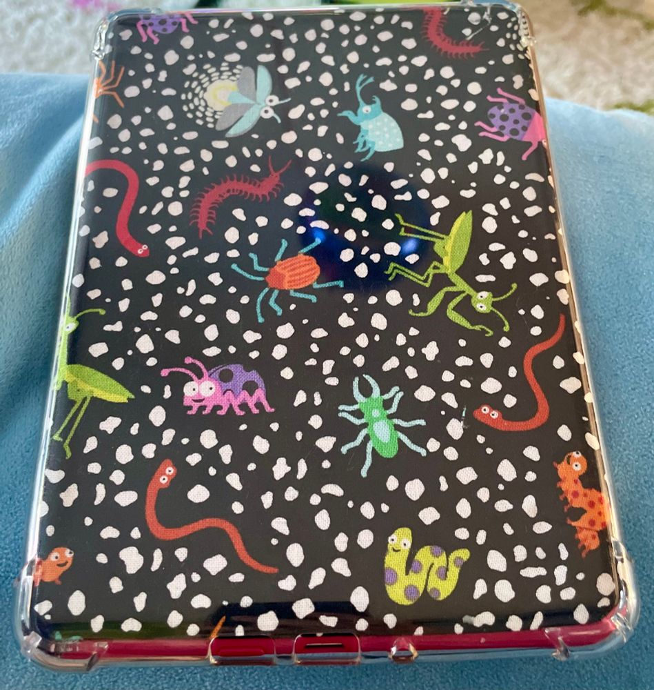 An image of the backside of a Kindle Paperwhite featuring an insect pattern 