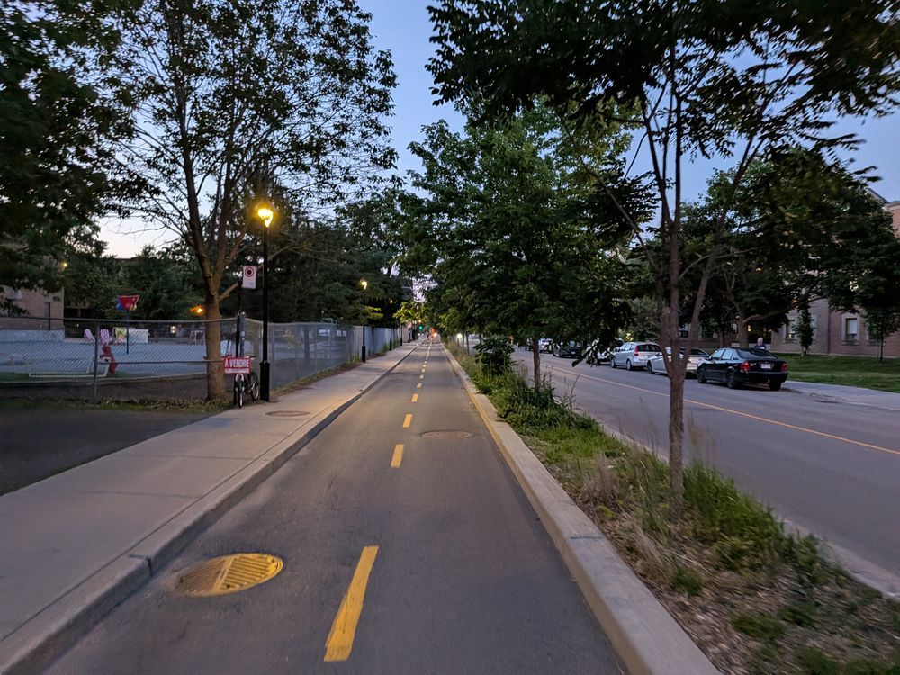 Common bike infrastructure in Montreal: two-way bike lanes separated from car traffic by a concrete median.