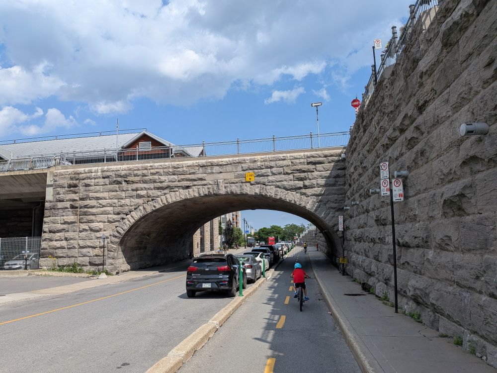 Eight year old riding a bike in Montreal in two-way bike lanes separated from car traffic by a concrete barrier.
