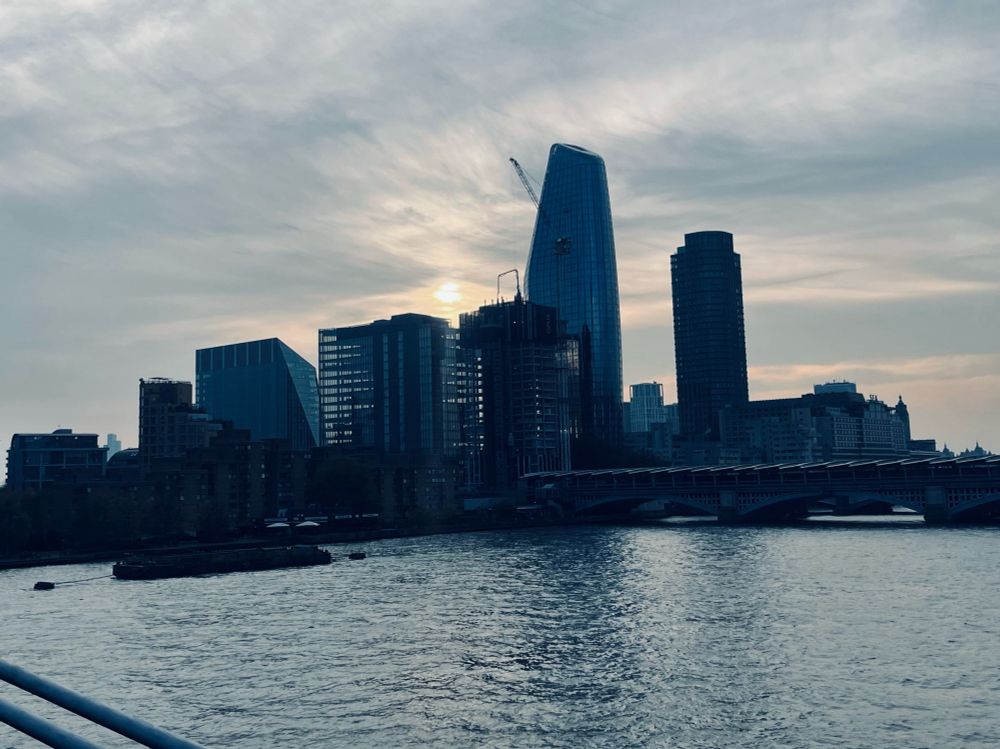 Big ol London buildings taken from a bridge across the Thames
