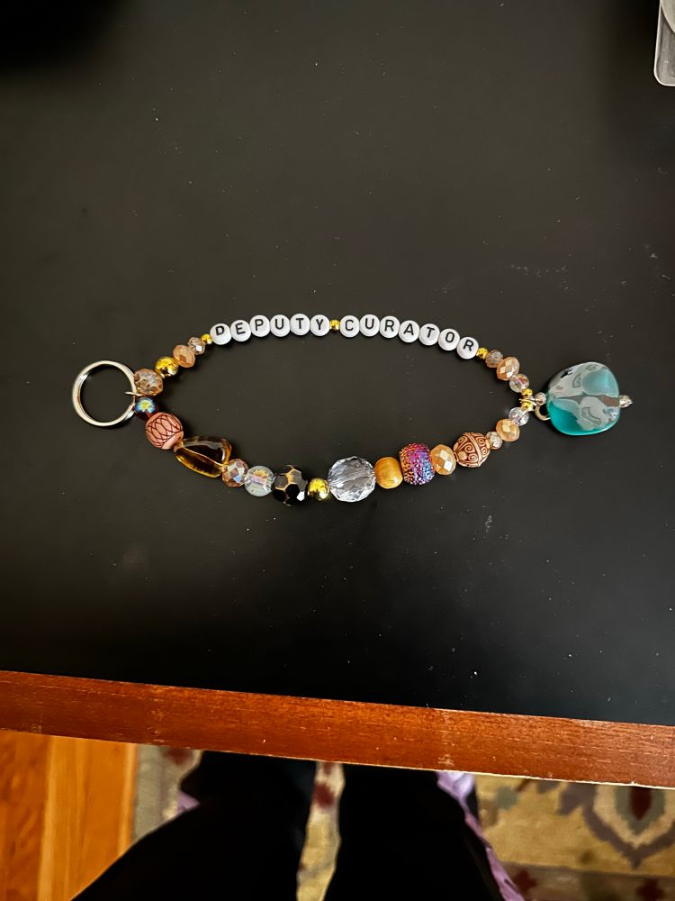 nancy drew keychain that says deputy curator 