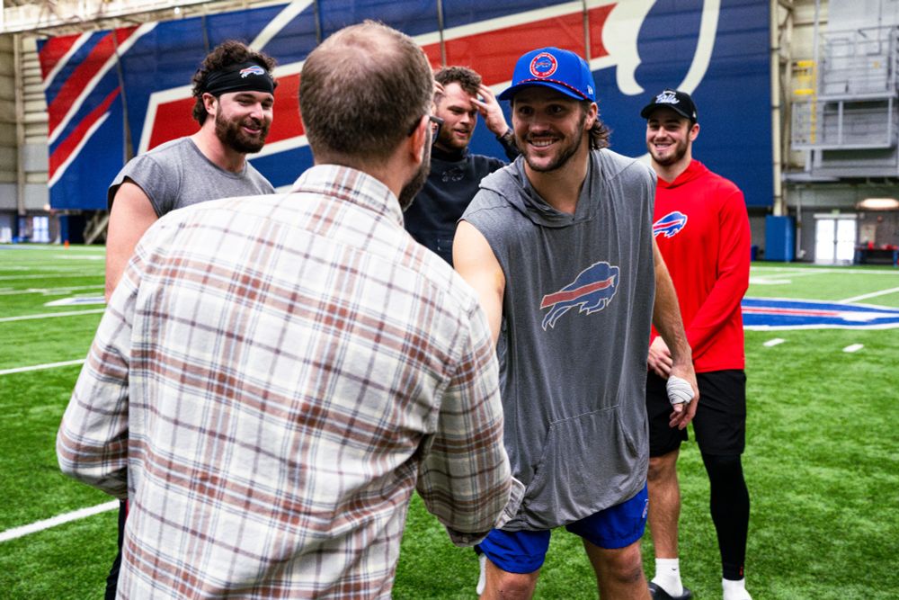A photo of me in the Buffalo Bills training facility shaking hands with Josh Allen while Dawson Knox, Spencer Brown, and Dalton Kincaid look on.