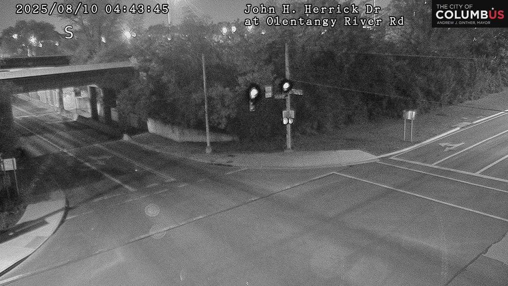 Typically shows a road or highway in Ohio with or without vehicles from a traffic camera.