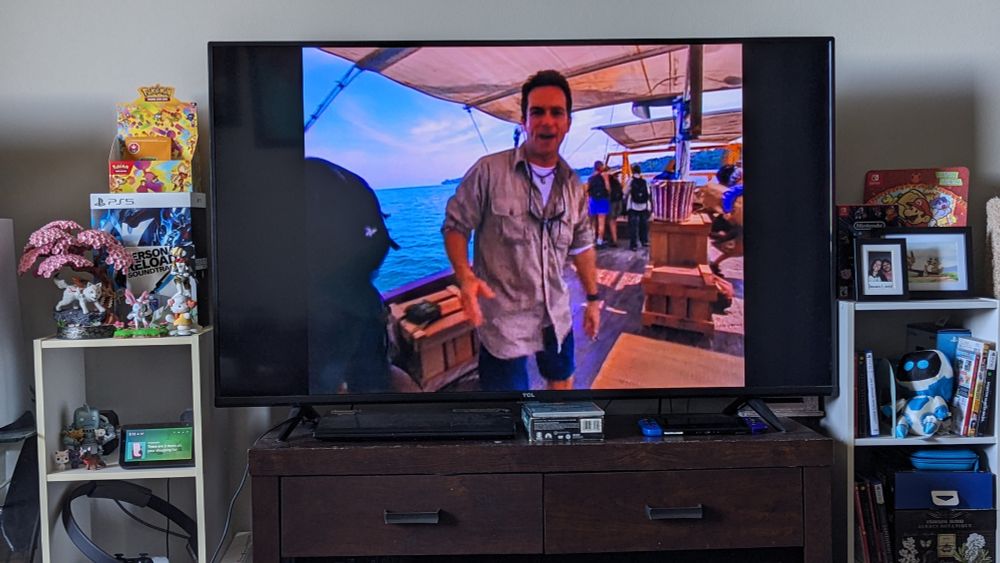 A television surrounded by knickknacks displaying the first episode of Survivor: Borneo.