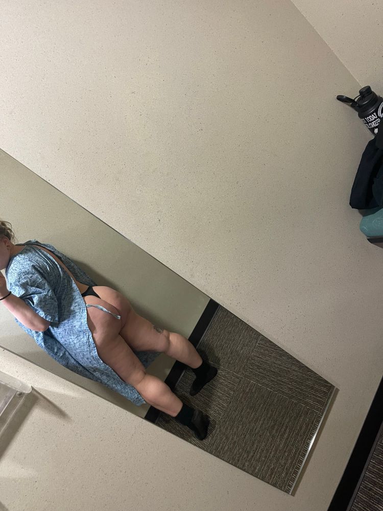 A picture of me in a changing room with socks, and thong, and a hospital gown on with my ass sticking out 