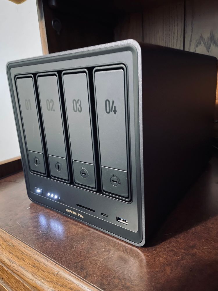 3/4 view of a UGreen 4800+ NAS, mostly focused on the front with four disk bays