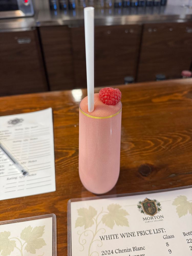 A pink wine slushy with a raspberry on top