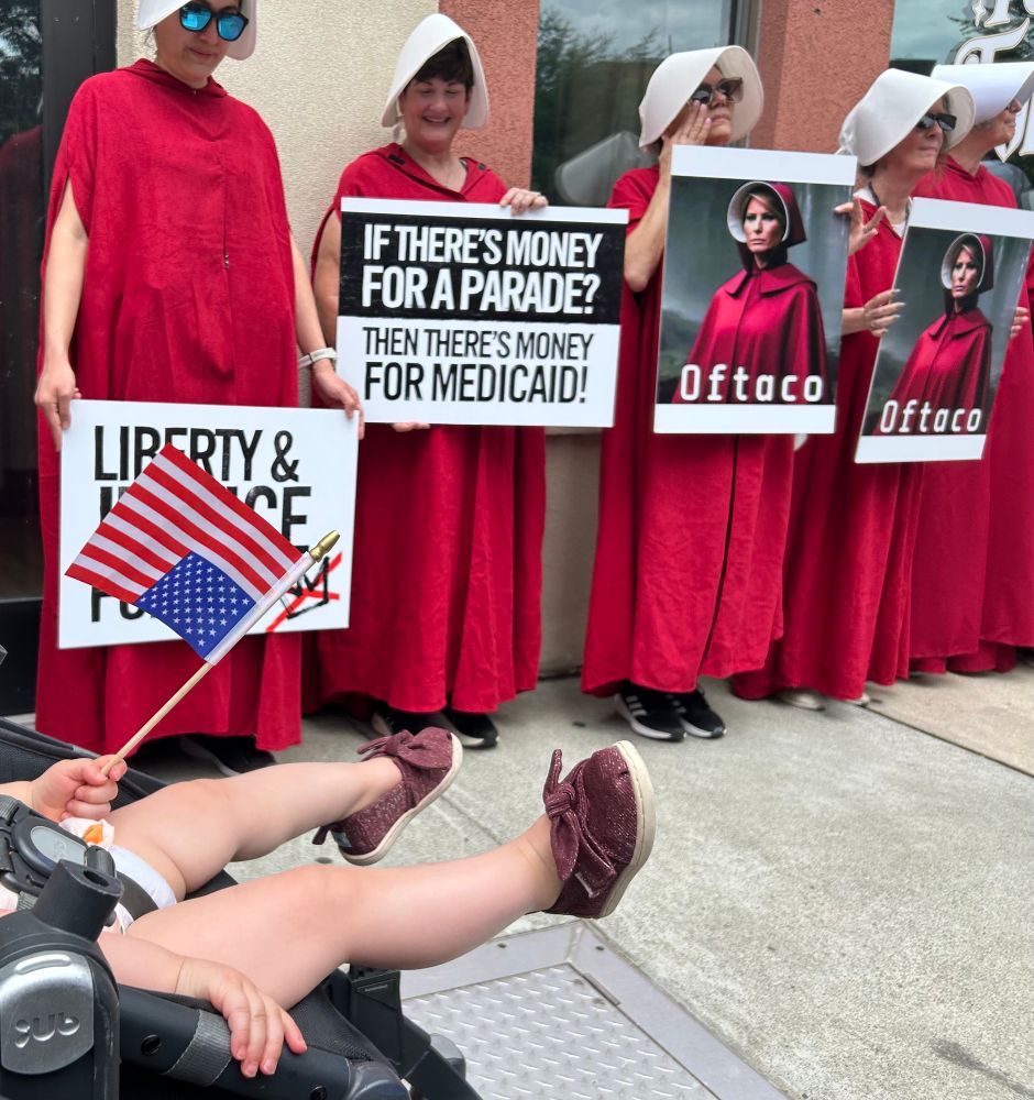 Women dressed up as handmaids at the rally