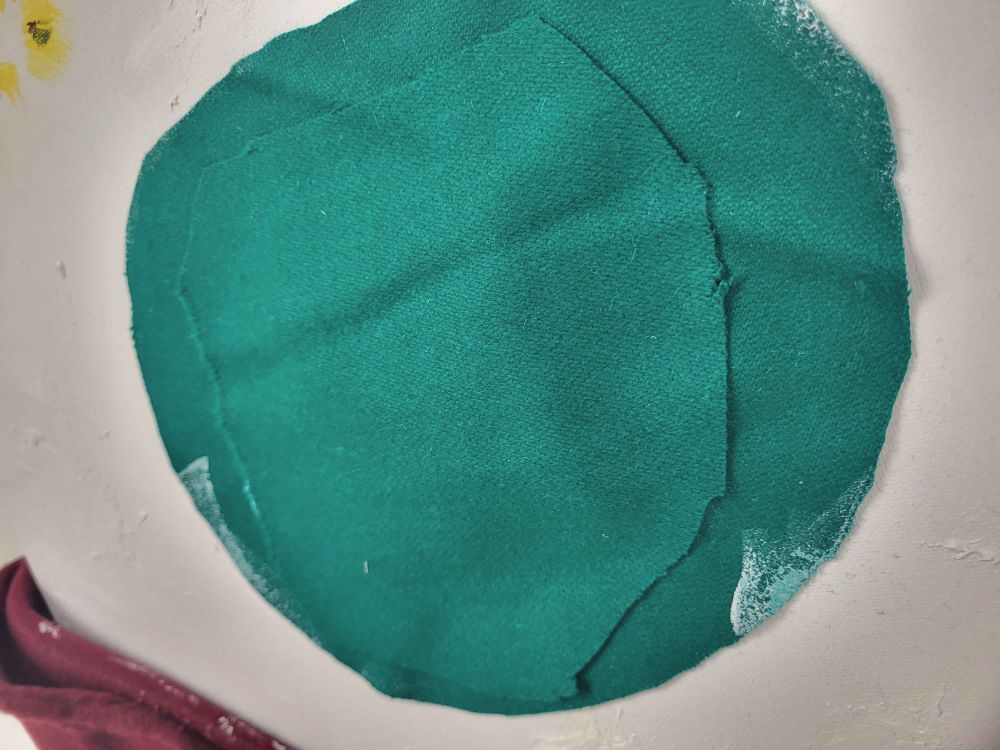 a second layer of pool table felt has been added to the original middle blotch. it is surrounded by more of the white acrylic/nail gel mix 