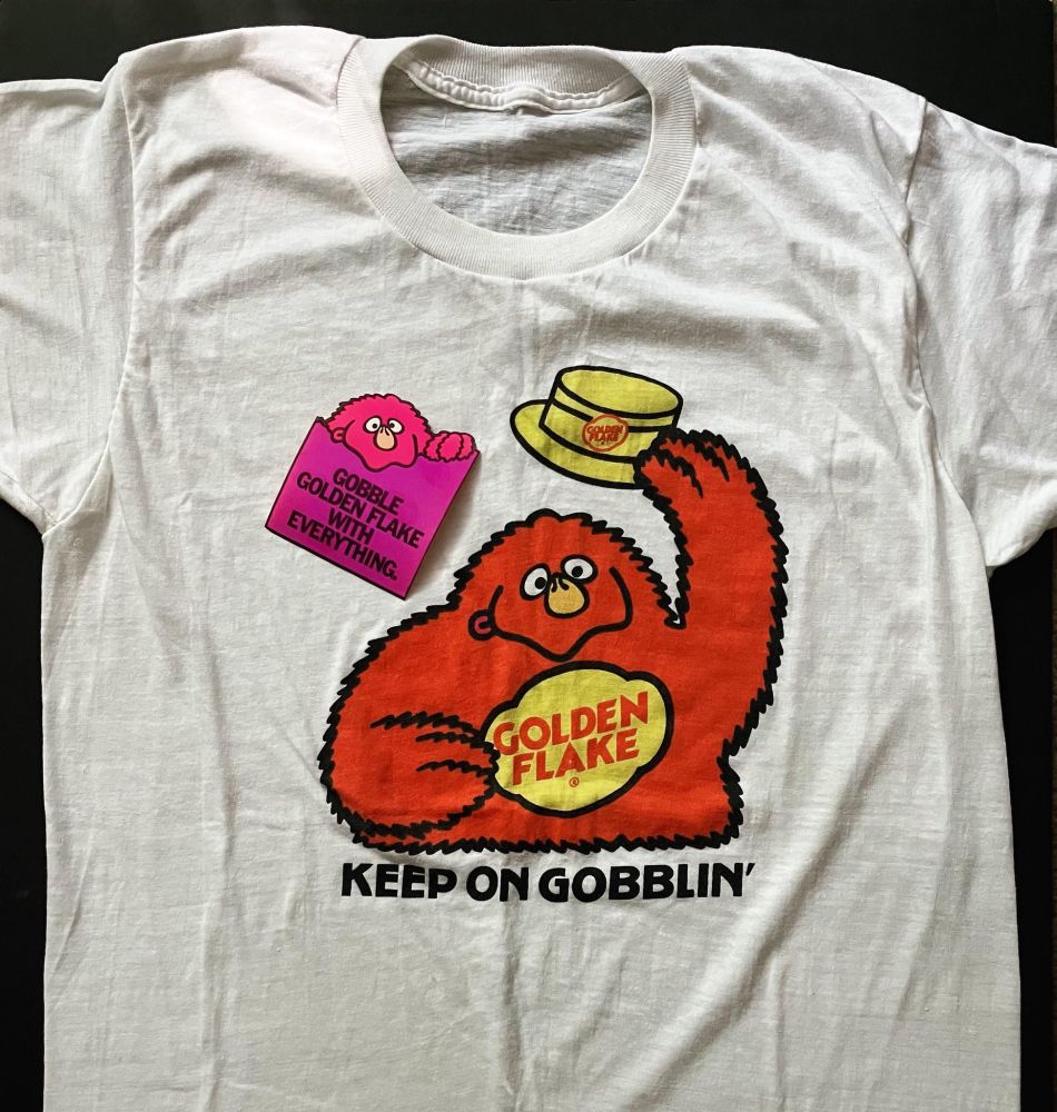 White T-shirt of the Gobbler raising his hat, text below reading, 