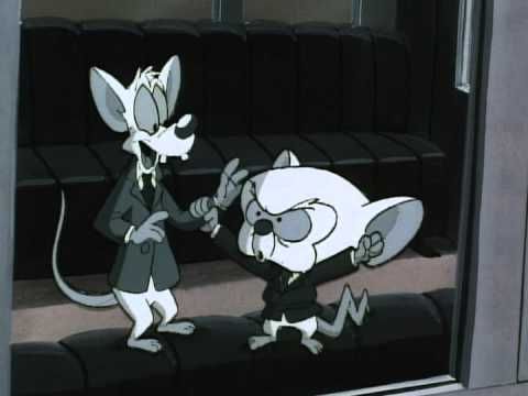 Pinky and the Brain in black and white wearing little suits. They're in a Ferris wheel car and Brain is ranting about the Swiss.