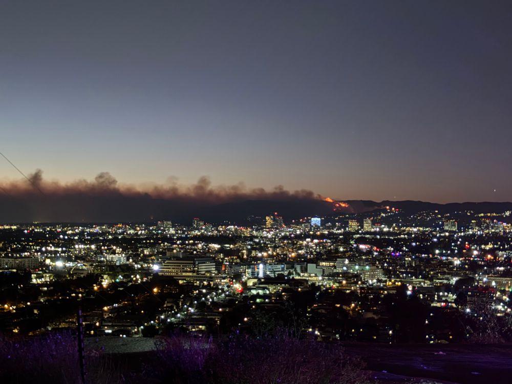 Palisade fire at night with the city in the foreground