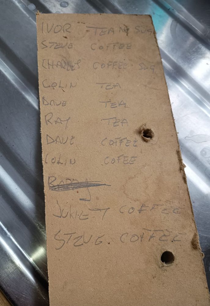 Board with names and coffee orders pencilled on it