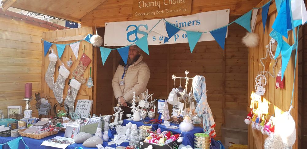 Another year another volunteer mans the stand with a selection of gifts laid out