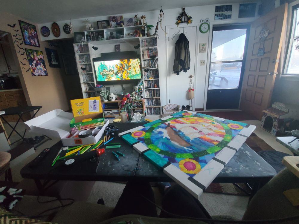 Redhead working on a crayon melting art project while binging Transformers movies