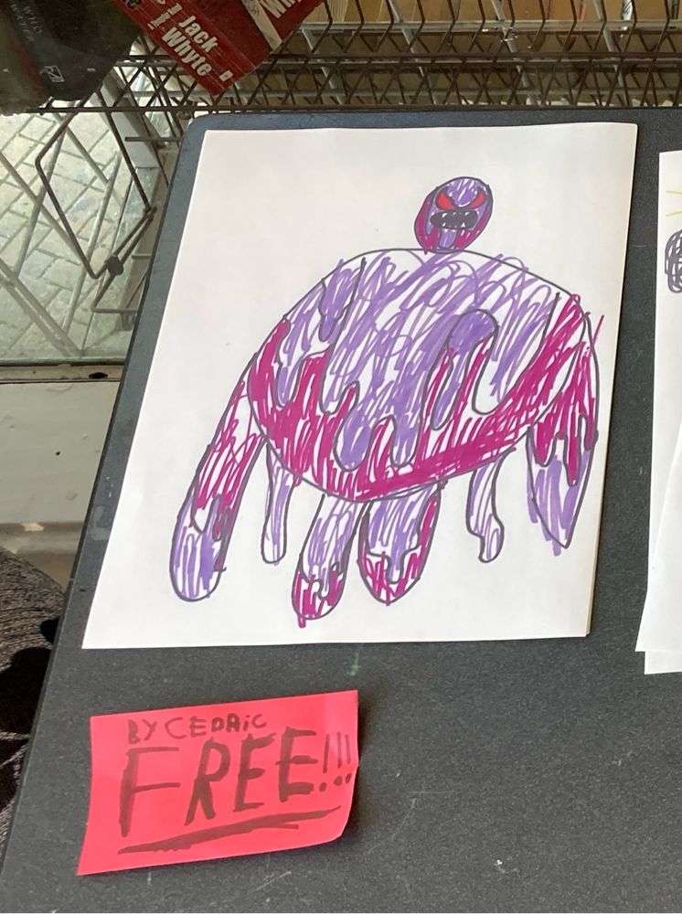 A fantastic drawing of what looks like a purple person drawn by what appears to be a kid names Cedric. There is a free sign in front of it