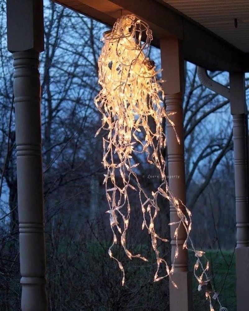 A jumbled strand of Christmas lights hangs from a single hook. 