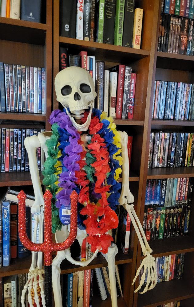 Larry the skeleton, decked out in the decorative accoutrement of leis and a bedazzled pitchfork from Party City.