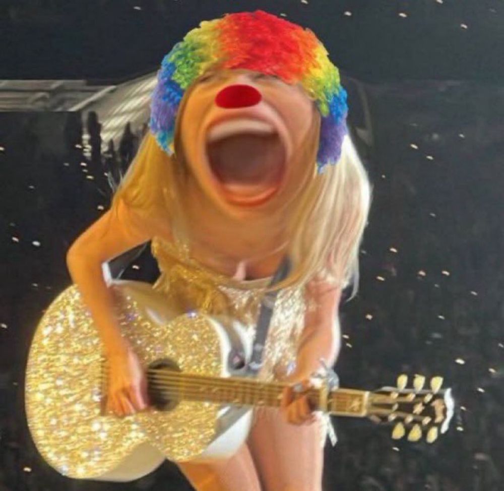 A meme of Taylor Swift in a sparkly outfit playing a glittery guitar on stage has a large, exaggerated open mouth, a clown nose, and a rainbow clown wig edited onto their face.