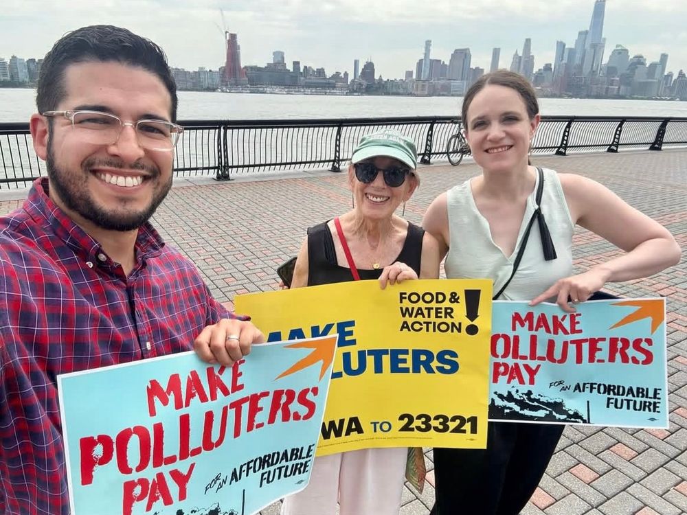 Ron, Liz and Eleana hold signs saying “make polluters pay for an affordable future”