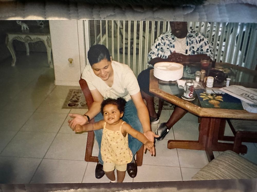 Jazzie as toddler with her mom helping her walk.