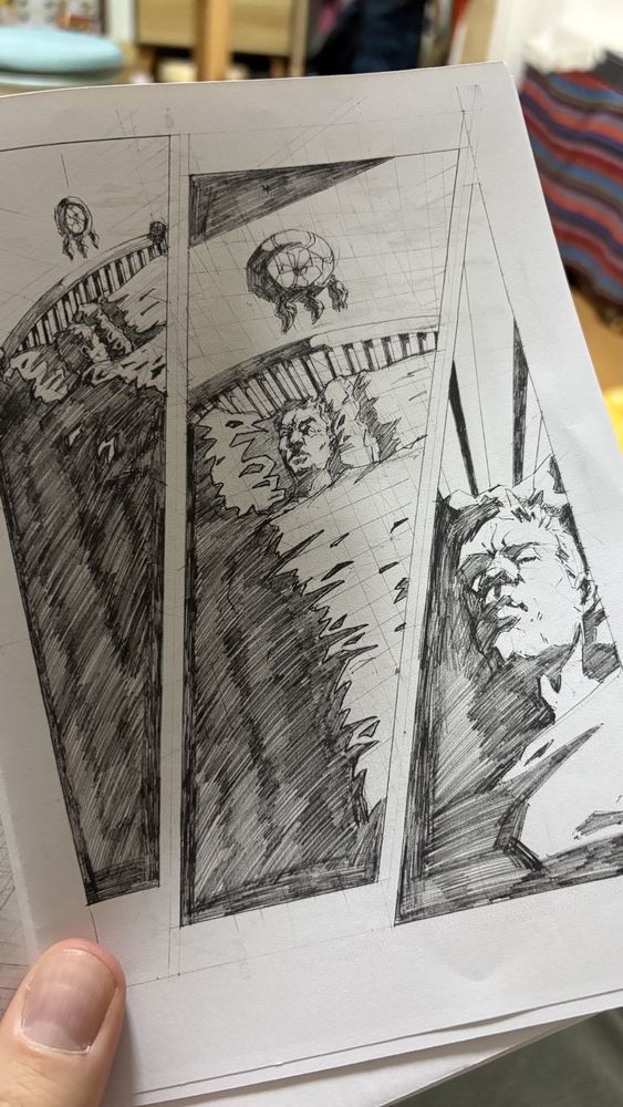 Photo of a printed comic page, the artwork on the page depicting a man asleep in a bed