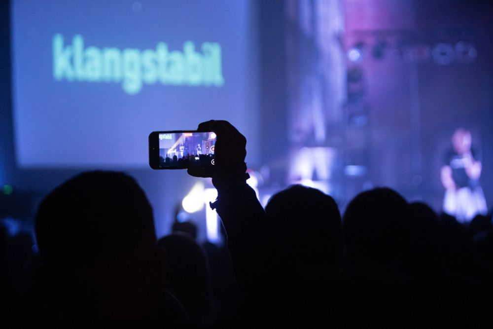 Someone recording the concert of Klangstabil at Planet Myer Day 2025 in Leipzig Industrial Concert Festival on his smartphone
