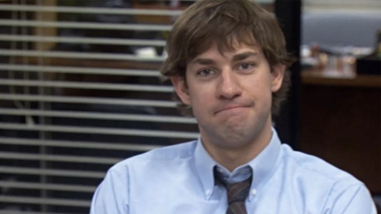 John Krasinski as Jim Halpert from The Office, looking smug. He has brown hair and is wearing a blue shirt with a tie (smugly)