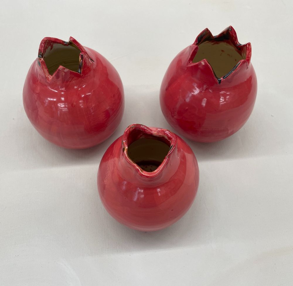Hand made ceramic vases shaped like pomegranites.