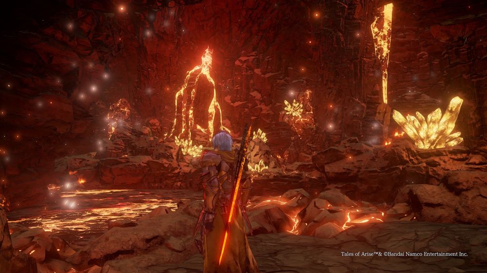 In front of character bottom left is a large lava pool and in the distance is a small lava fall with 5 strands flanked with orange glow crystals. There is a 1 stream of lava falling to the right with a larger crystal in front.