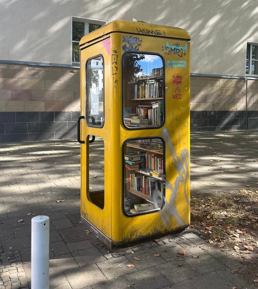 Old-fashioned telephone booth repurposed into a modern-day 'lending library' in Cologne, Germany