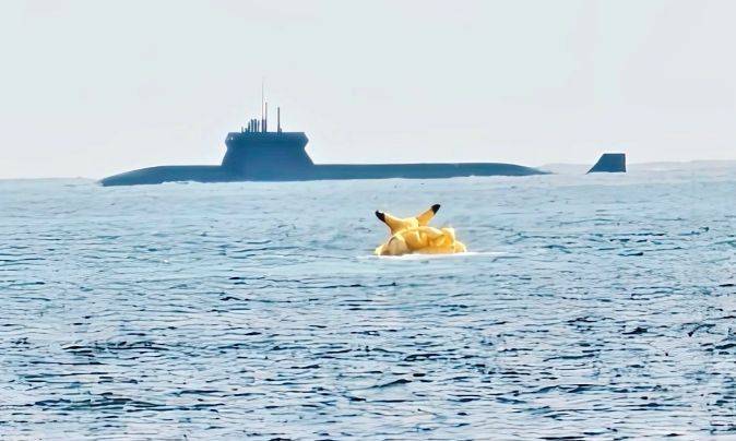 Chinese submarine on surface with Pikachu themed towable boat in midground