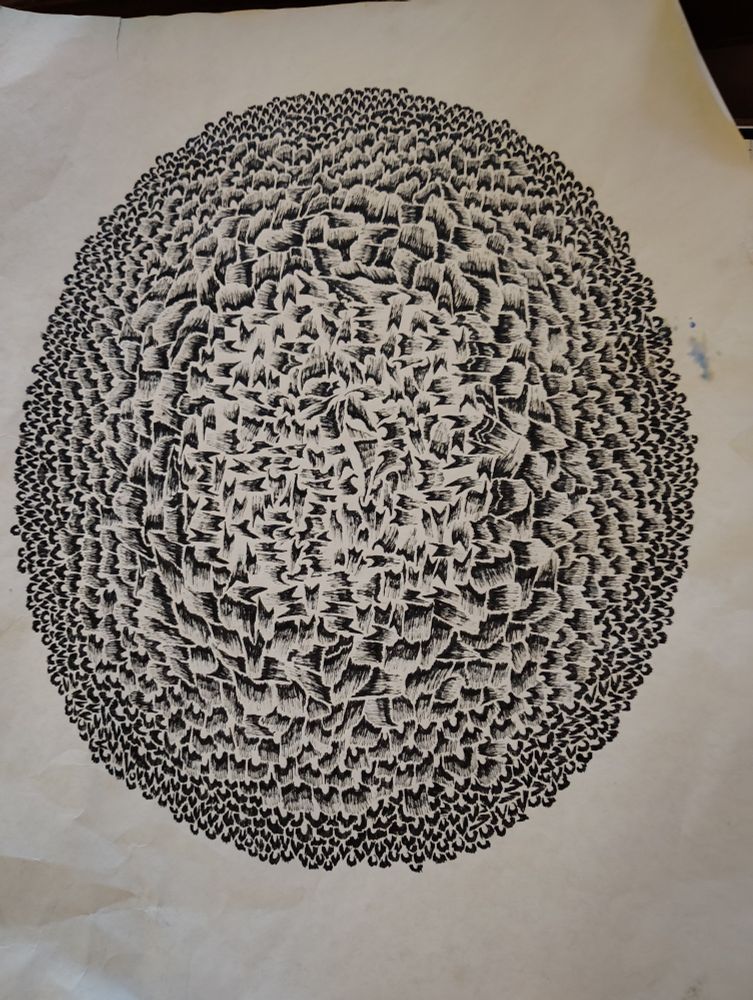Freehand pen-and-ink abstract artwork consisting of gradient black lines in varying and somewhat random patterns. The various patterns combine to form a roughly oval design. 