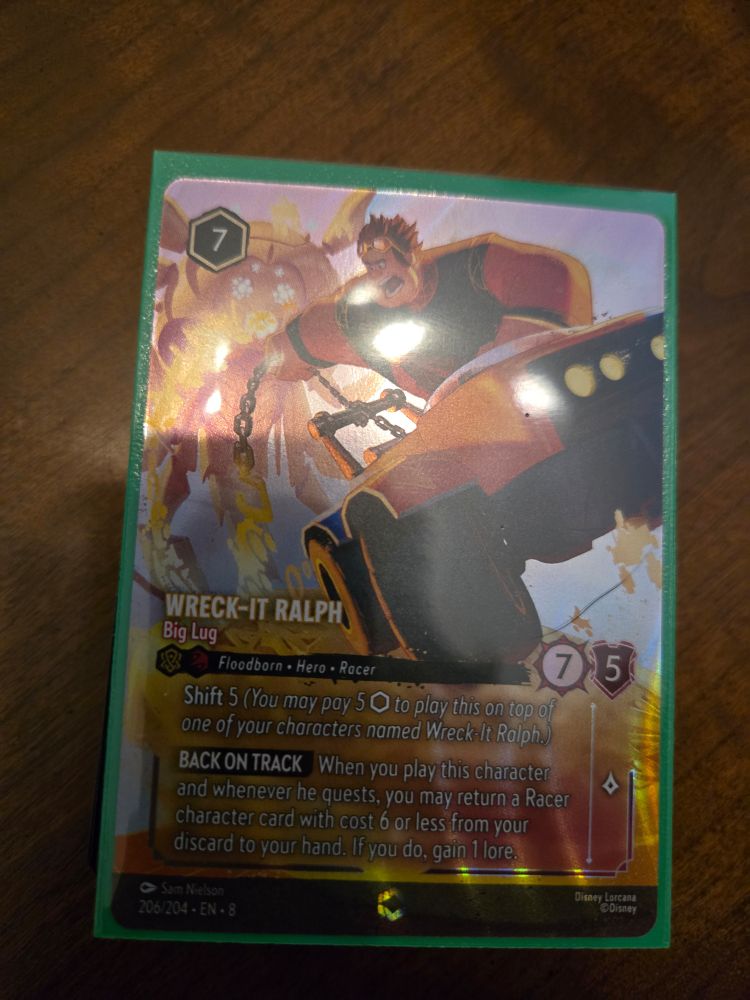 Lorcana trading card of Wreck It Ralph riding a buggy type of car while yelling and pointing 