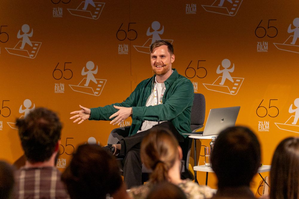 Michael delivering a lecture at the Zlin Film Festival, wearing a Britney Spears microphone.