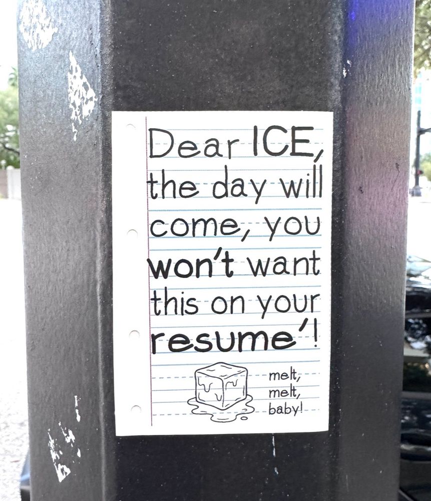 Sticker that looks like a piece of notebook paper with a kids handwriting font, on a black pole reads: Dear ICE the day will come, you won't want this on your resume!! - melt, melt, -baby!
