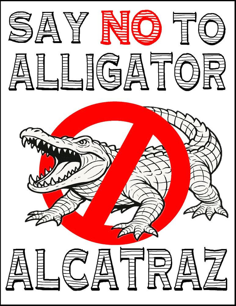 Sign has a picture of an alligator with a 🚫 over it. 

Reads:

SAY NO TO ALLIGATOR
ALCATRAZ